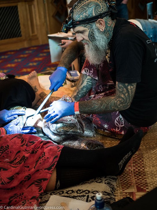 Rosie Edwards is giving Brent Mccown a helping hand while he's tattooing Diogo Nunes.